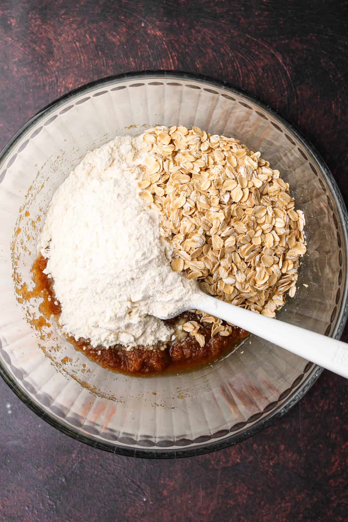 Making the crumb topping for an apple pear crisp with flour and oats.