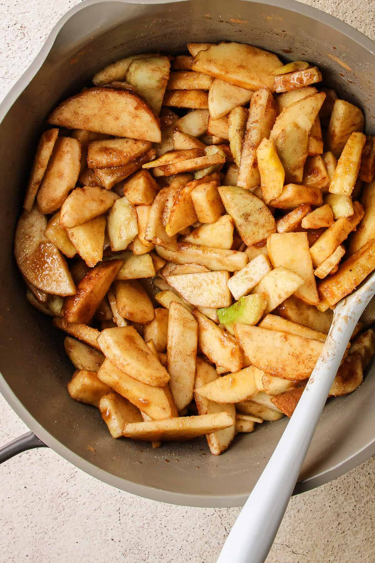 A pot with the ingredients for apple pie filling.
