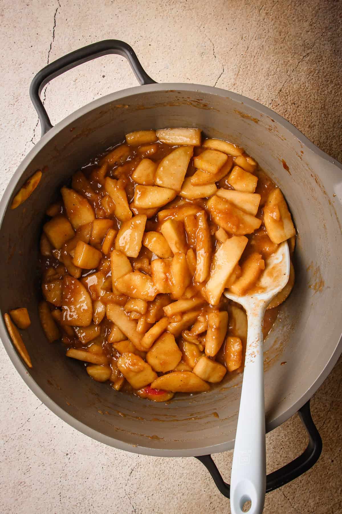 Cooked apple pie filling in a pot for puff pastry apple pie.