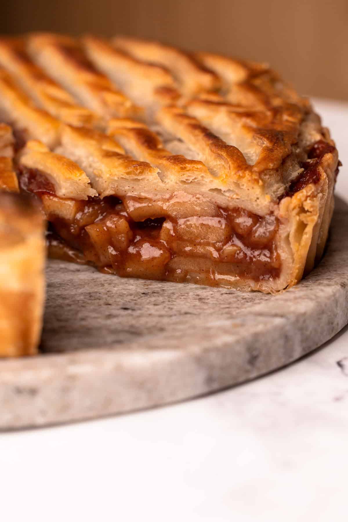 A puff pastry apple pie sliced to reveal the juicy apple filling.