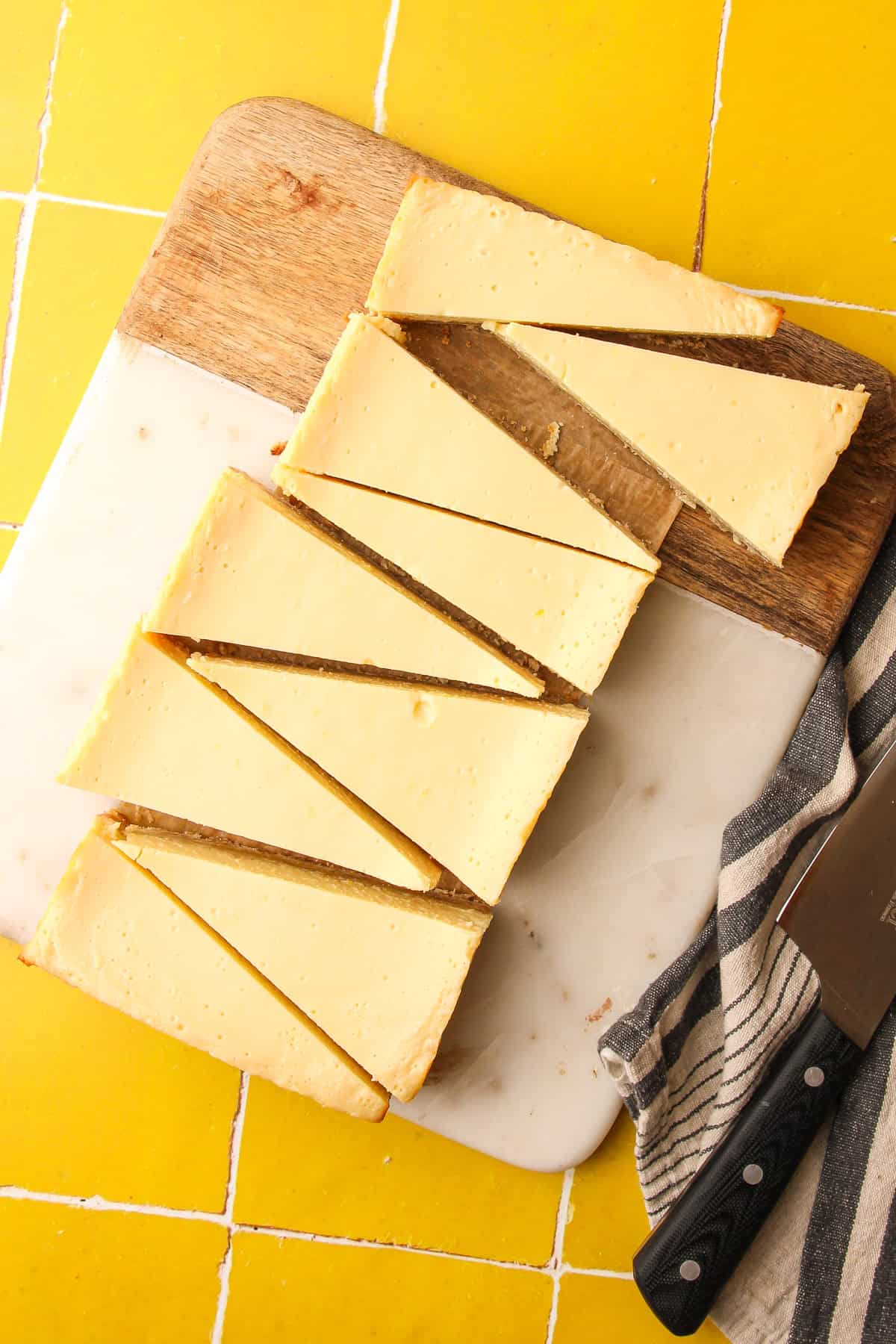 Small batch lemon pie bars with a smooth lemon filling and buttery press in crust cut into triangles on a cutting board.