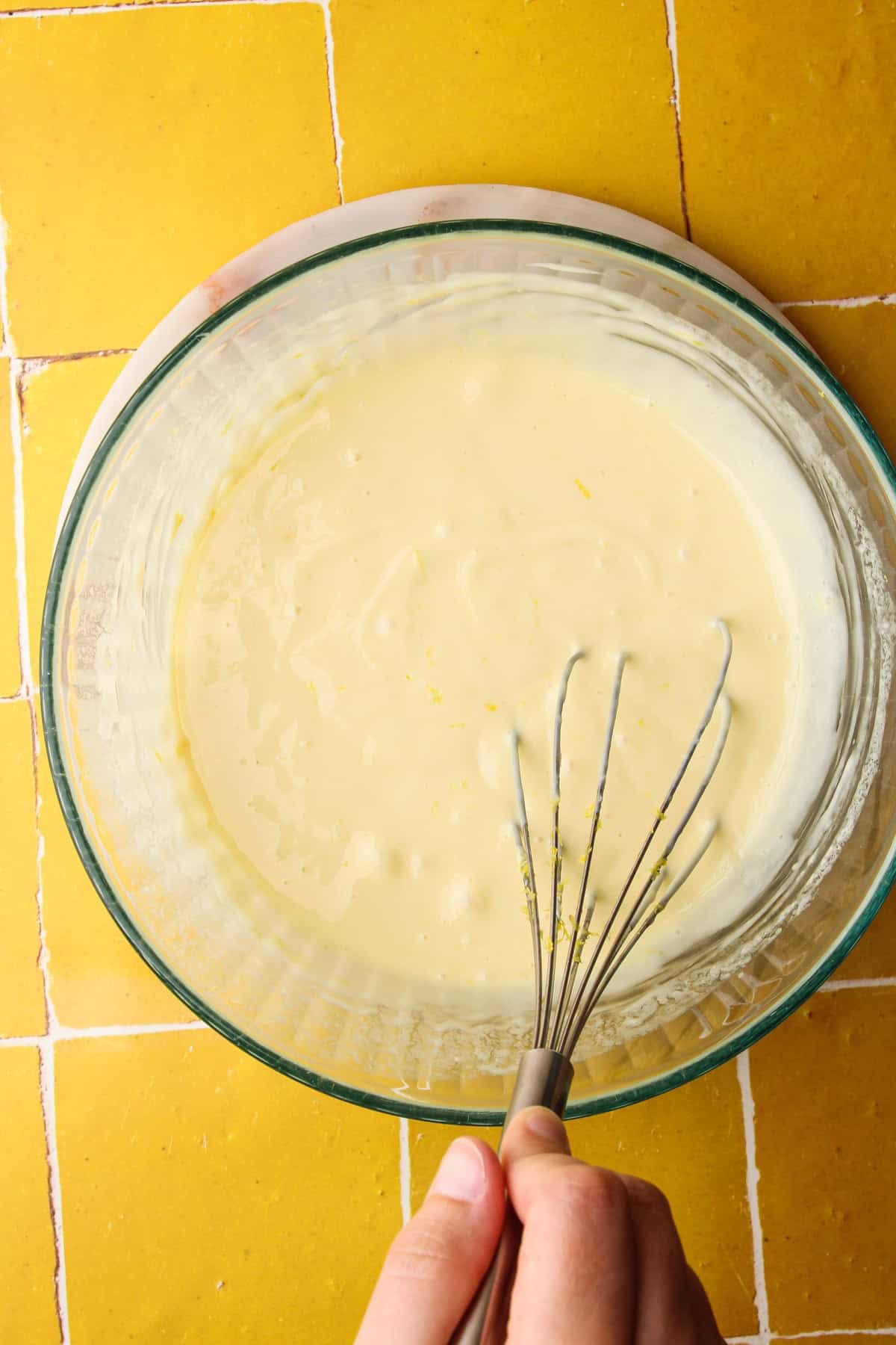Whisking together the ingredients for the filling of lemon pie bars.