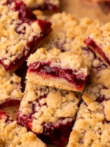 Baked cherry pie bars sliced and arranged to show the juicy filling.