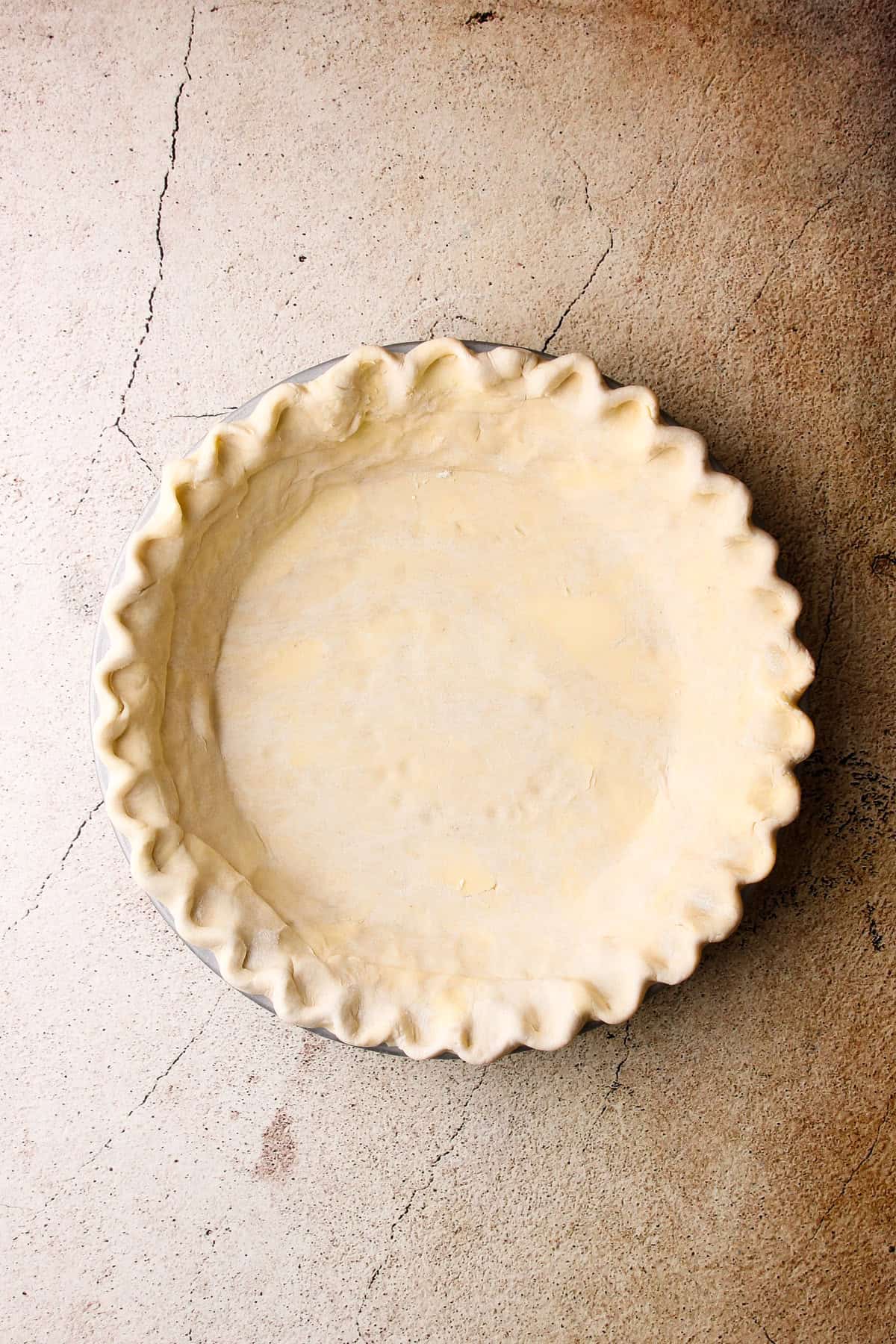 The prepared pie crust for an apple crumb pie.